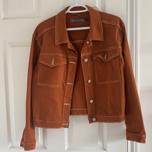 Brown jean jacket with white stitching